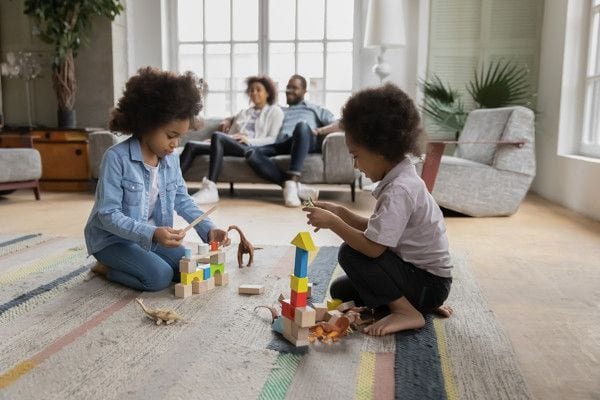 https://www.speedheat.us/wp-content/uploads/2020/09/kids-playing-on-warm-rug-buddy-rugbuddy-while-parents-relax-on-sofa.jpg